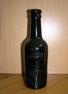 Бутылка из темно-зеленого стекла. Надпись : "THOMAS WILLIAMS PWLLHELI * VICTORIA STORES".
